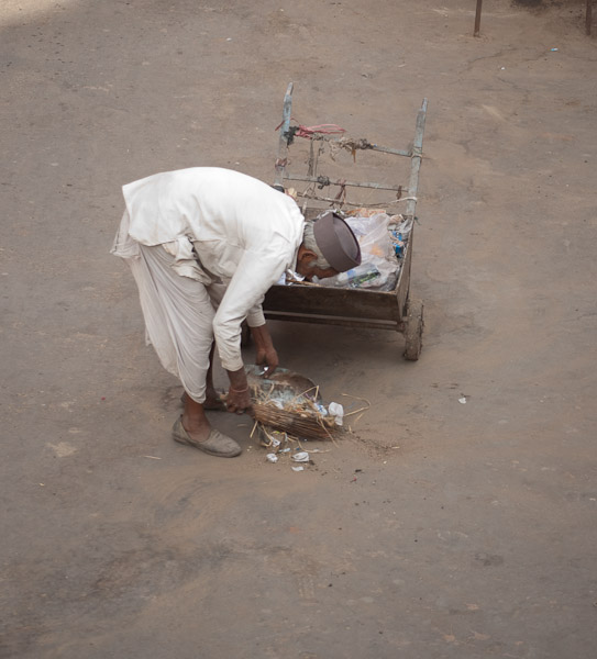 India_JanFeb_10_Pushkar_5990.jpg - Street sweeper  from where I ate breakfast.  They throw and empty trash into the streets.