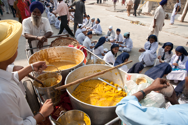 _DSC1160.jpg - Feeding the marchers.  Dal (lentil soup) on the left, and a sweet rice? paste on the right. Small pail is to carry the dal.